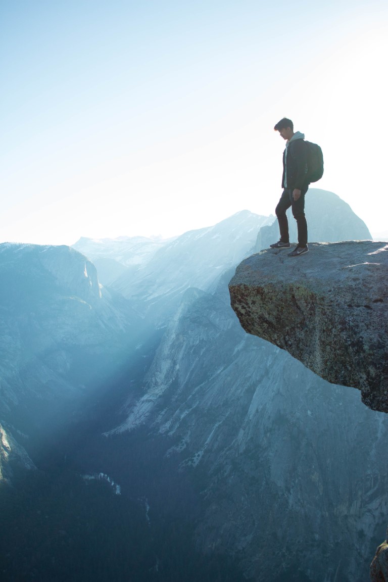 Photograph of one person standing on the rock