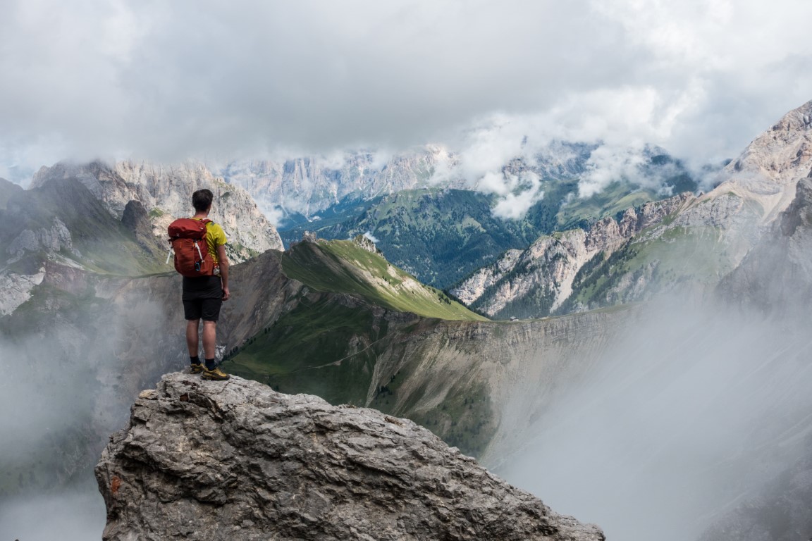Photograph of one person standing on the rock