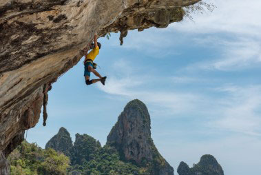 Photograph of one person climbing a mountain
